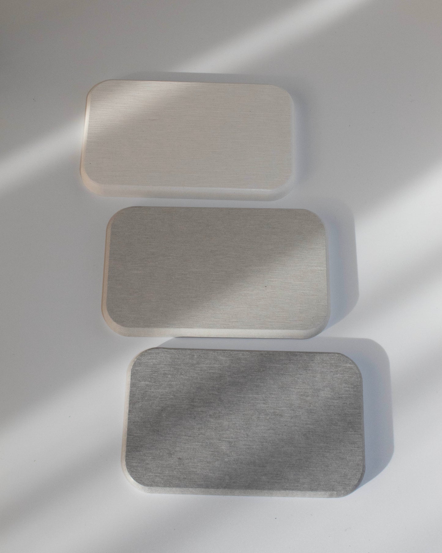 Textured diatomaceous diatomite absorbent bathroom counter coaster in white warm grey cool grey rectangle
