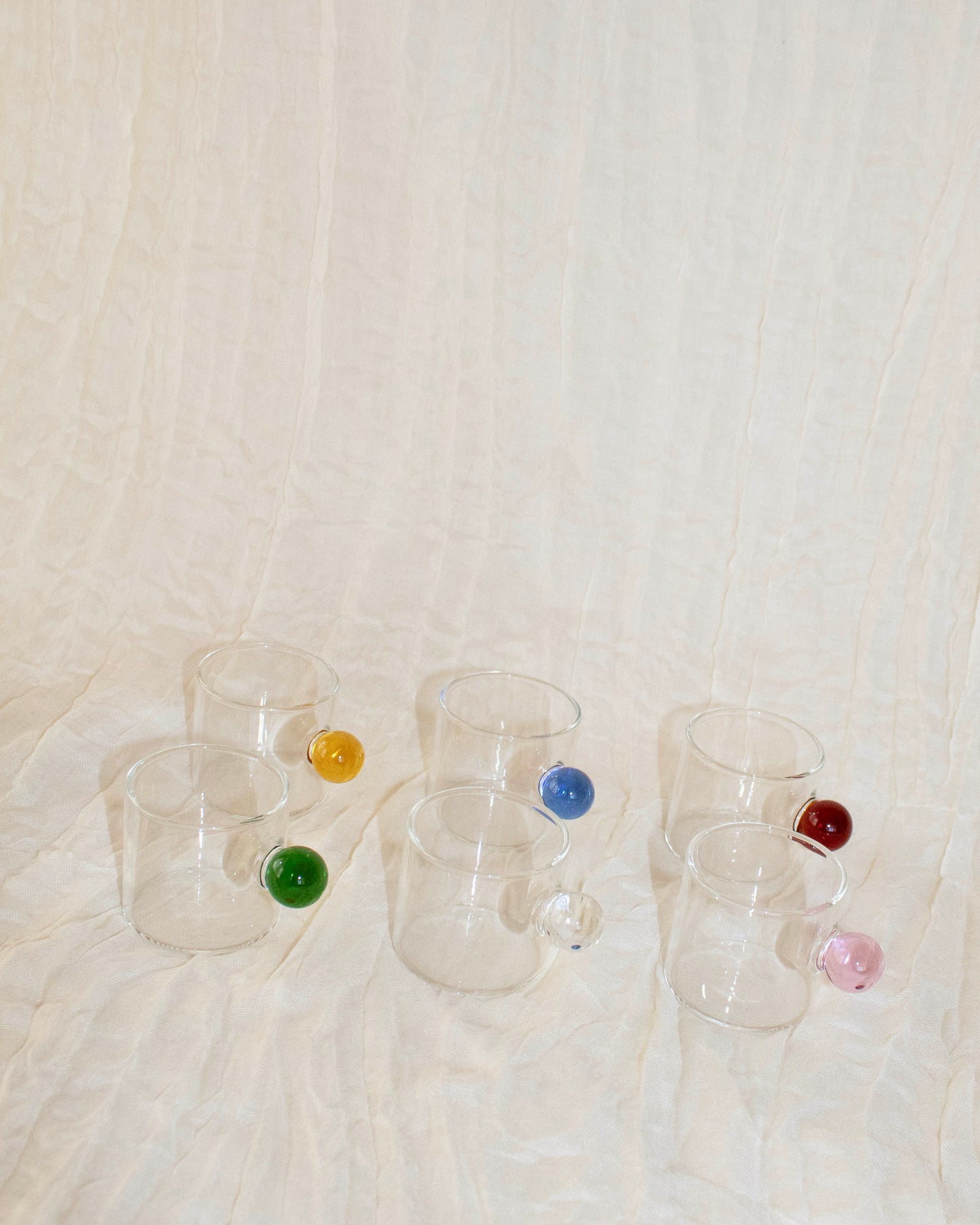 Elegant clear glass cup with a minimalist design for hot and cold drinks.