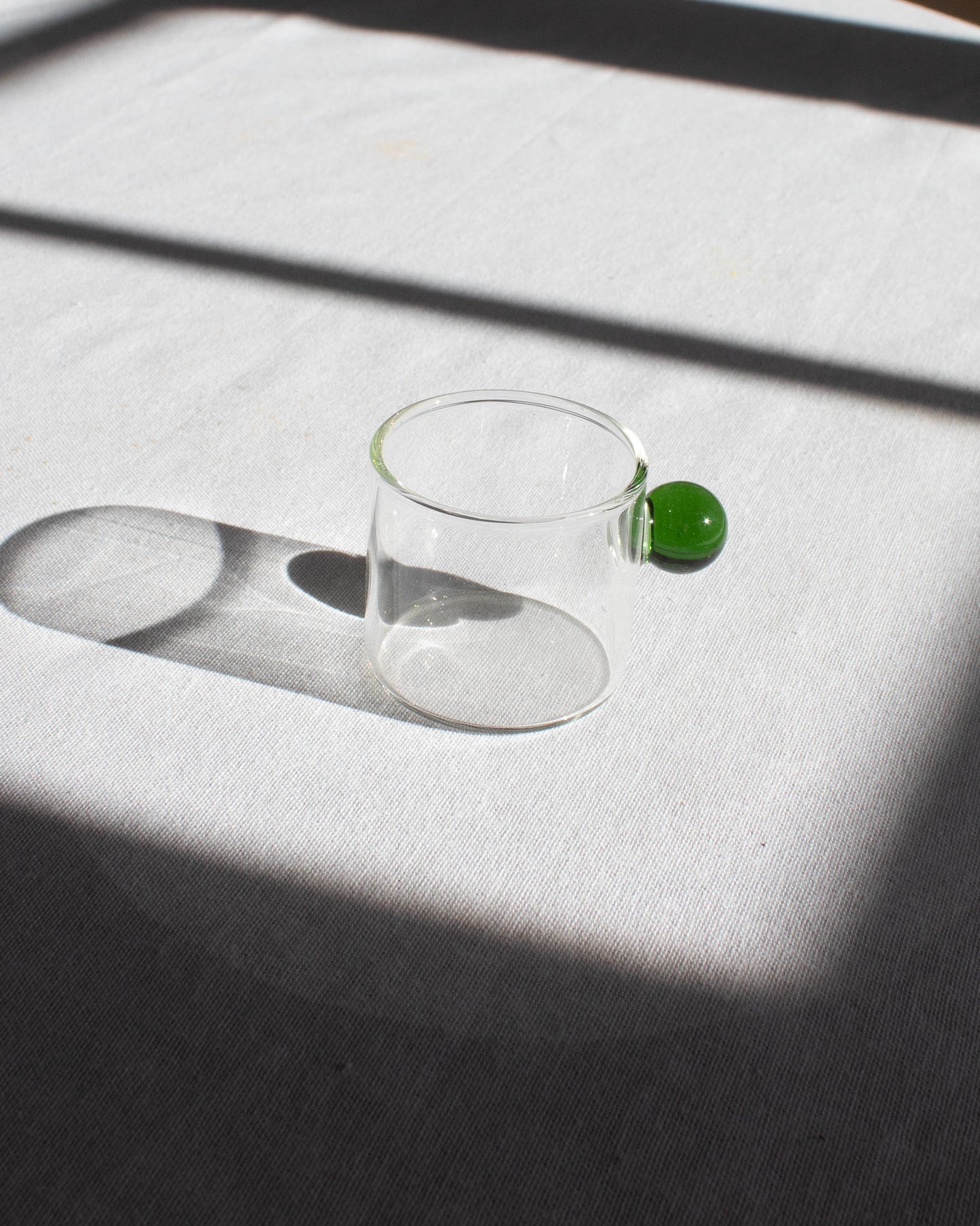 Elegant clear glass cup with a minimalist design for hot and cold drinks.