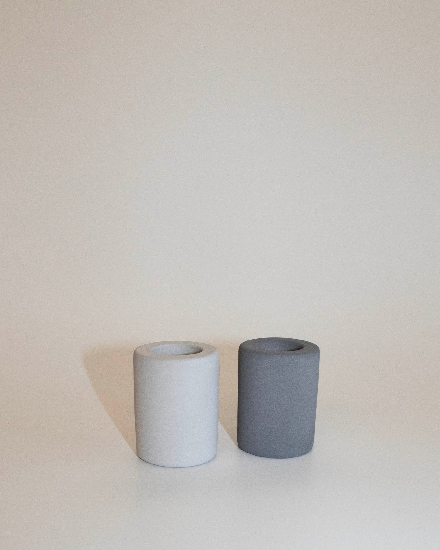 Set of two diatomite toothbrush holders in light and dark grey side by side